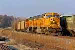 BNSF 8836 works Past a grain train in the siding.